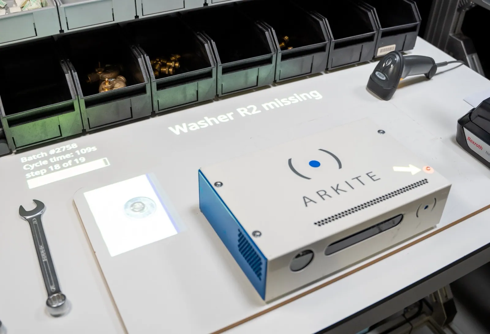 Arkite VISION workstation projecting the message Washer R2 missing next to the product, with an arrow pointing to the missing washer