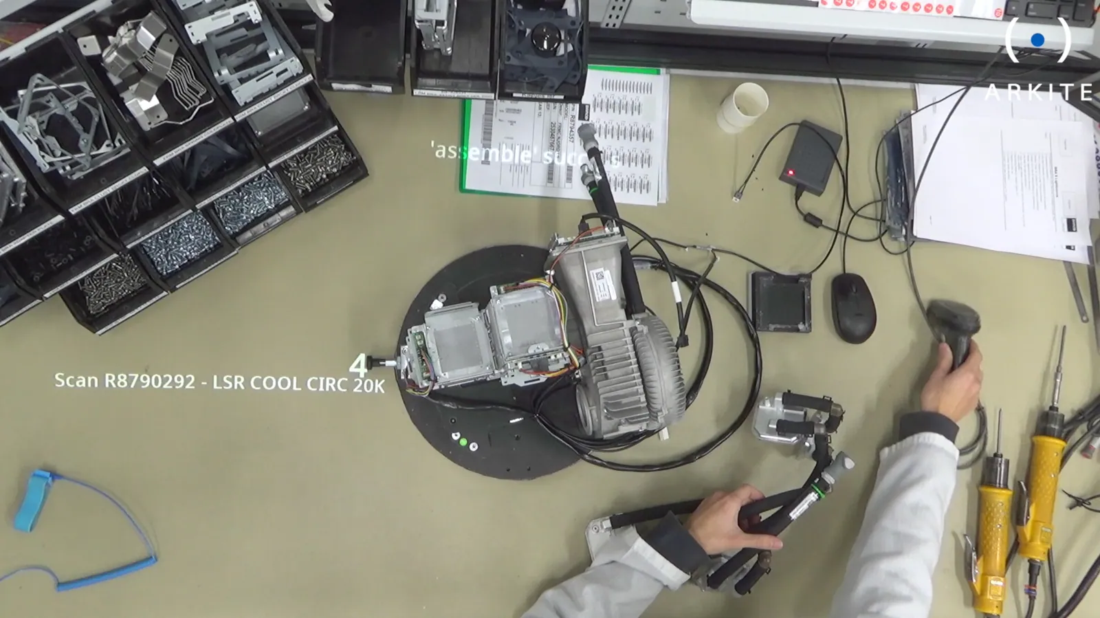 Top view of a Barco workstation with projected step instructions next to the product