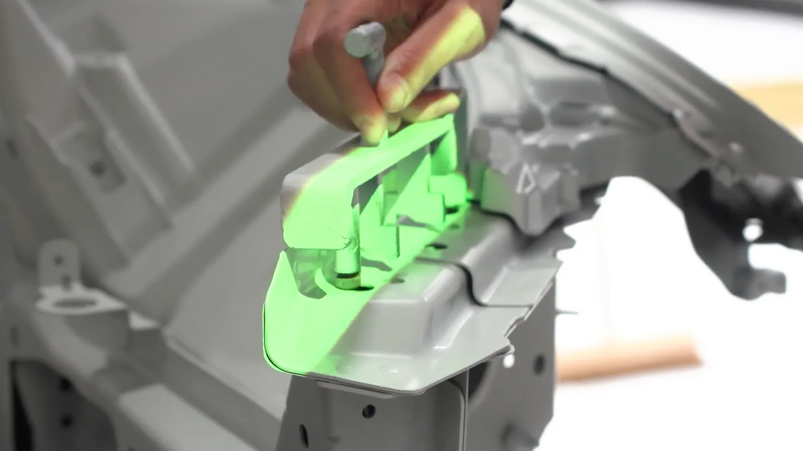 Close-up of a projected highlight confirming the correct position of a component on a vehicle body