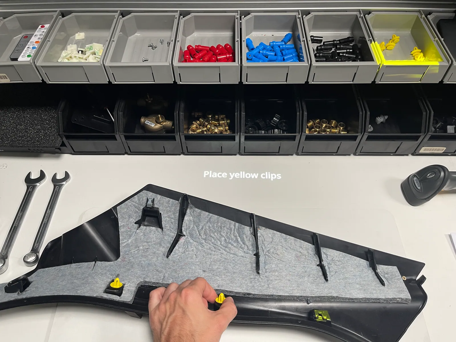 Projected instruction tells the operator to place the yellow clips