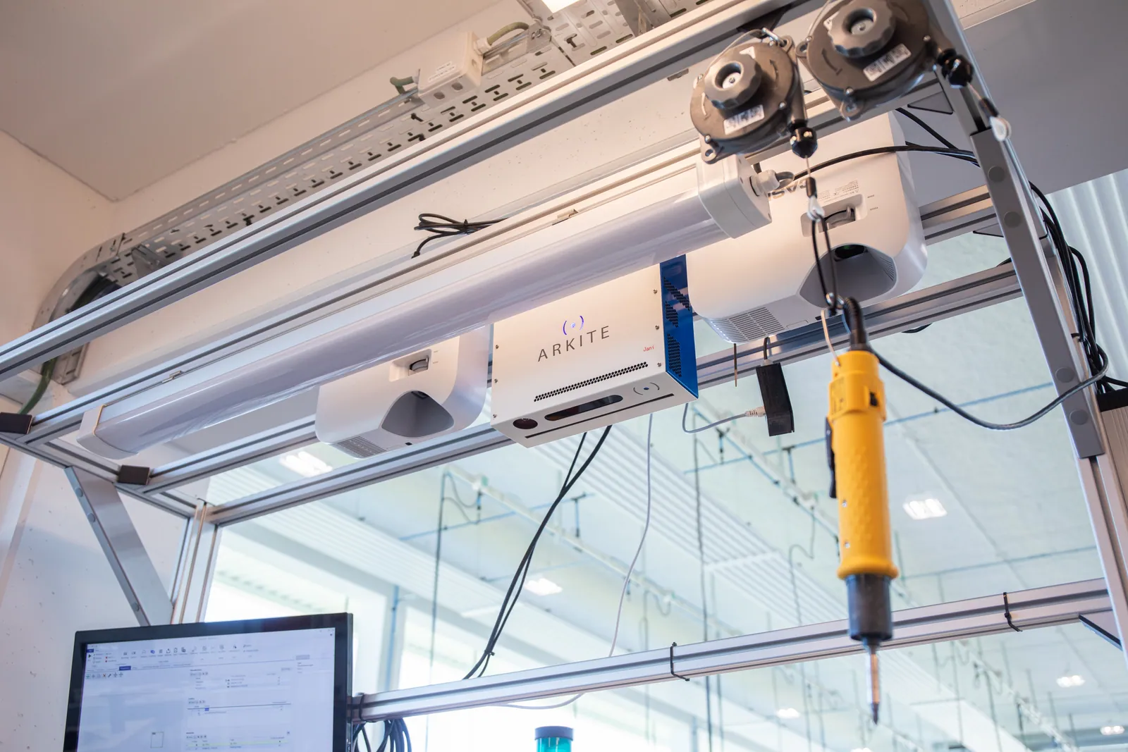 Arkite sensor and projectors mounted above a manual workstation with a smart screwdriver and operator screen